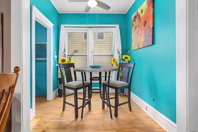 1221 S Madison St, Appleton, WI 54915 - dining space with crown molding, baseboards, ceiling fan, and light wood-type flooring