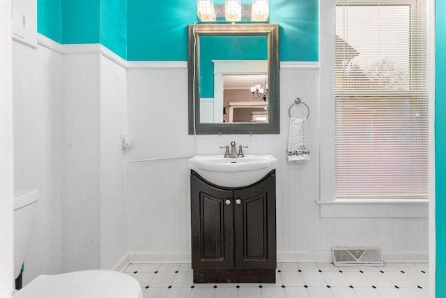 1221 S Madison St, Appleton, WI 54915 - bathroom featuring visible vents, vanity, toilet, tile patterned floors, and a wealth of natural light