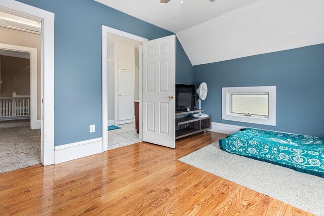 1221 S Madison St, Appleton, WI 54915 - bedroom with baseboards, vaulted ceiling, and wood finished floors