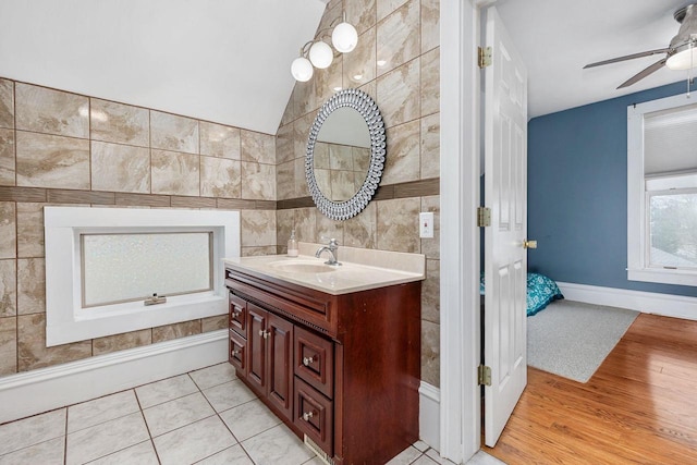 1221 S Madison St, Appleton, WI 54915 - bathroom with vanity, a ceiling fan, wood finished floors, and tile walls