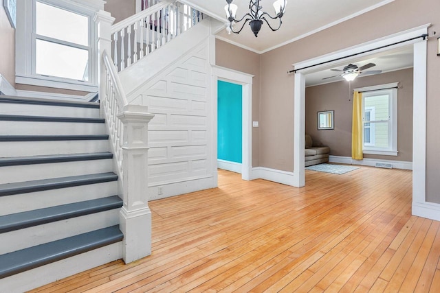1221 S Madison St, Appleton, WI 54915 - interior space featuring crown molding, visible vents, hardwood / wood-style floors, baseboards, and ceiling fan with notable chandelier