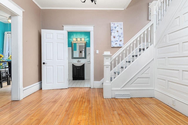 1221 S Madison St, Appleton, WI 54915 - stairs with crown molding, baseboards, wood-type flooring, and visible vents