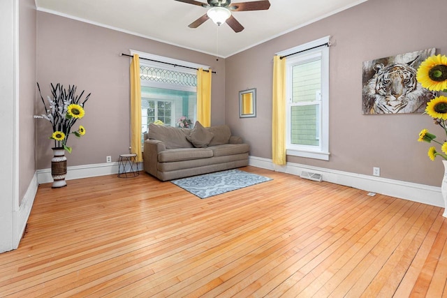 1221 S Madison St, Appleton, WI 54915 - living room featuring crown molding, a ceiling fan, light wood-type flooring, and visible vents