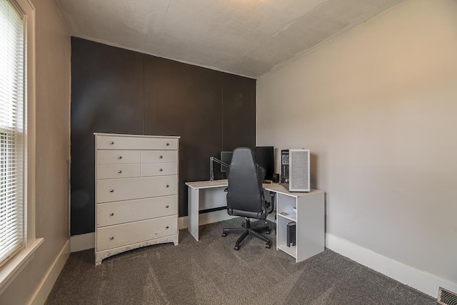 home office featuring baseboards, dark colored carpet, and visible vents