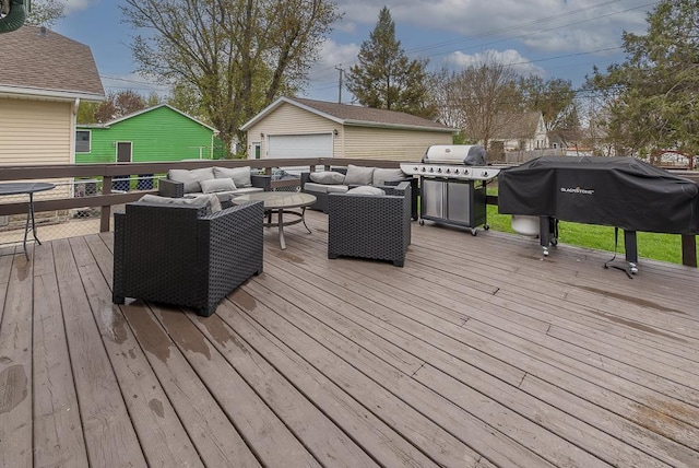 deck featuring an outdoor living space, an outdoor structure, a garage, and area for grilling
