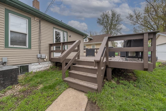 wooden deck with a yard and cooling unit
