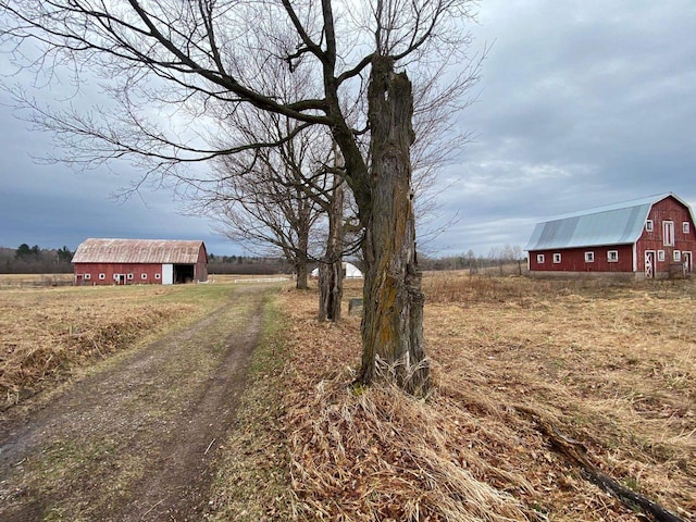186 Abrahams Rd, Skandia, MI 49885 - view of road with a barn, driveway, and a rural view