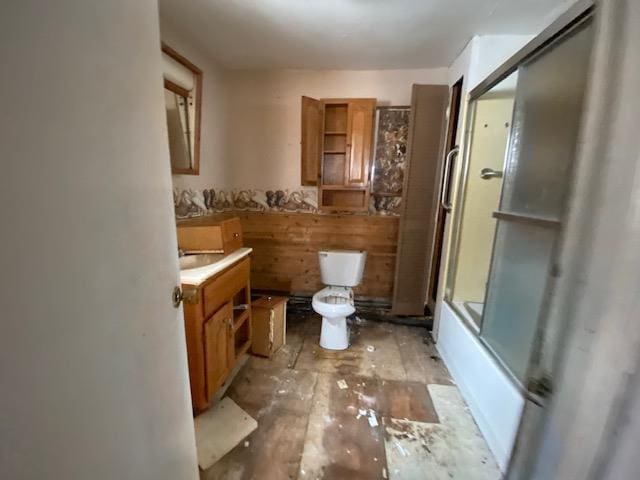 186 Abrahams Rd, Skandia, MI 49885 - bathroom featuring vanity, hardwood / wood-style flooring, toilet, and shower / bath combination with glass door