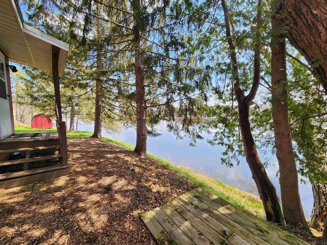 26297 State Highway 60, Lone Rock, WI 53556 - view of yard featuring a storage unit, a water view, and an outdoor structure