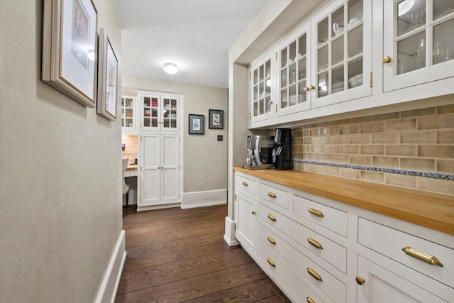 hall with baseboards and dark wood finished floors