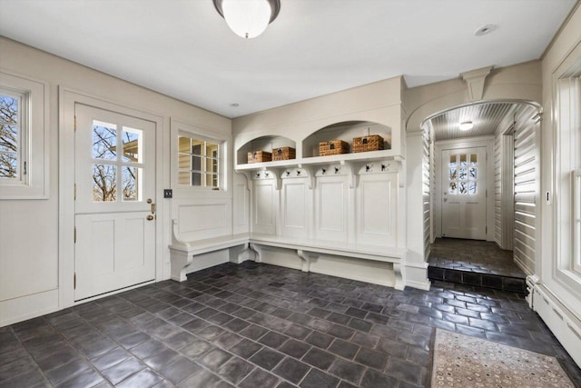 mudroom featuring a baseboard heating unit and a wealth of natural light
