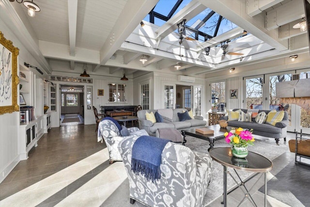 tiled living room featuring a skylight, a wall mounted AC, french doors, and beam ceiling