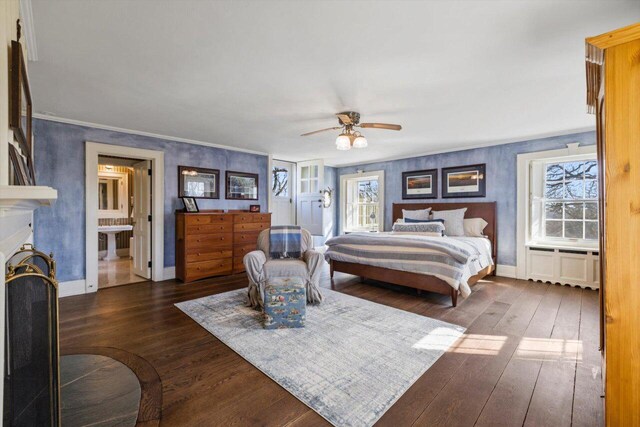 bedroom featuring a ceiling fan, baseboards, dark wood-style floors, and ornamental molding