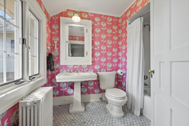 bathroom with toilet, wallpapered walls, and radiator heating unit