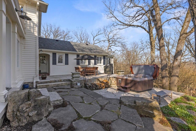 view of patio / terrace with a hot tub and outdoor dining space