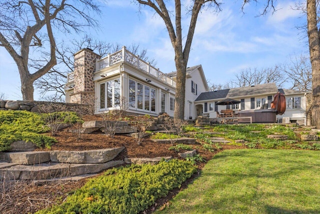 back of property featuring a lawn