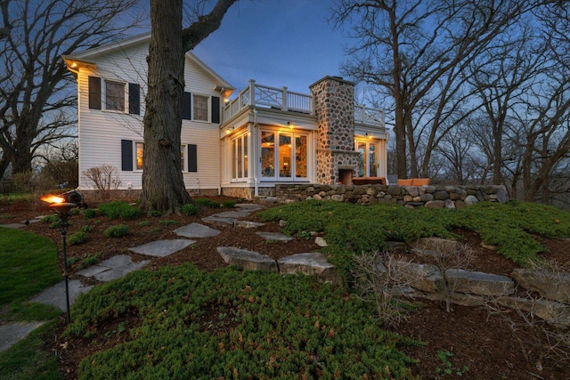 rear view of property with a balcony