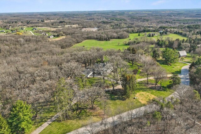 birds eye view of property featuring a forest view