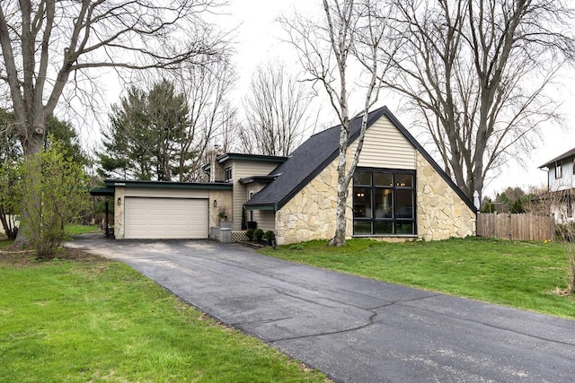 view of front of home with aphalt driveway, a garage, fence, a front lawn, and stone siding