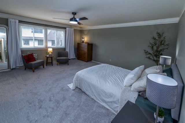 carpeted bedroom featuring crown molding and a ceiling fan