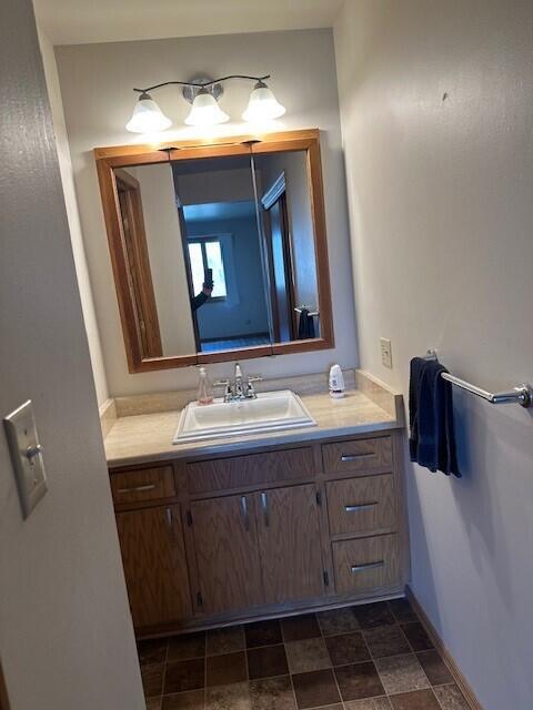 bathroom with vanity and baseboards