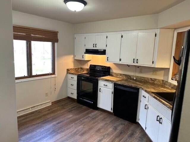 kitchen featuring a baseboard radiator, white cabinetry, black appliances, and extractor fan