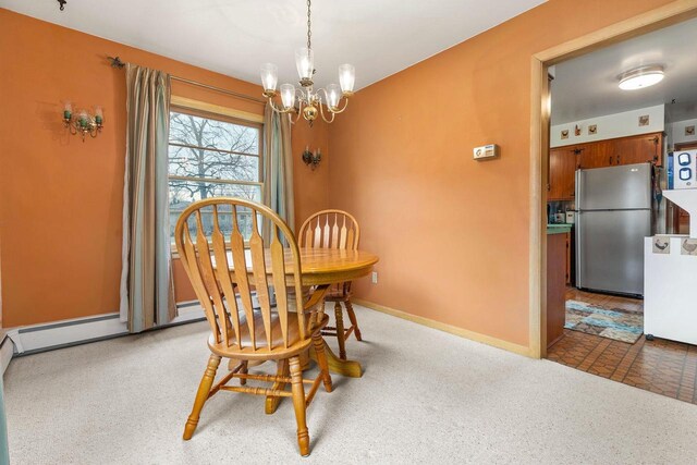 901 E Grant St, Appleton, WI 54911 - carpeted dining area with an inviting chandelier and baseboards
