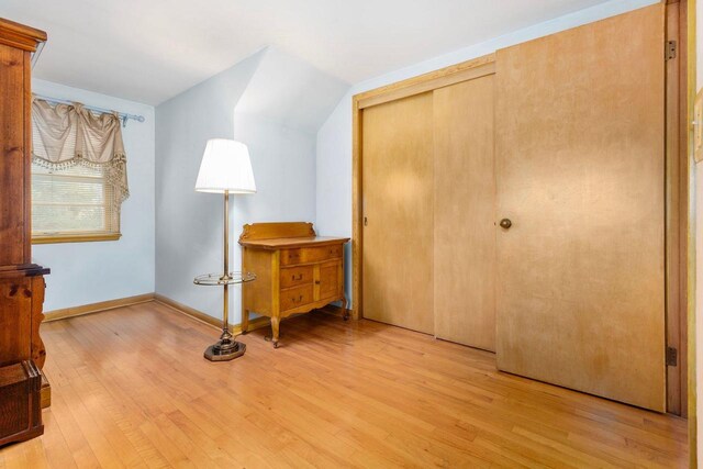 901 E Grant St, Appleton, WI 54911 - bedroom with light wood-type flooring, baseboards, vaulted ceiling, and a closet