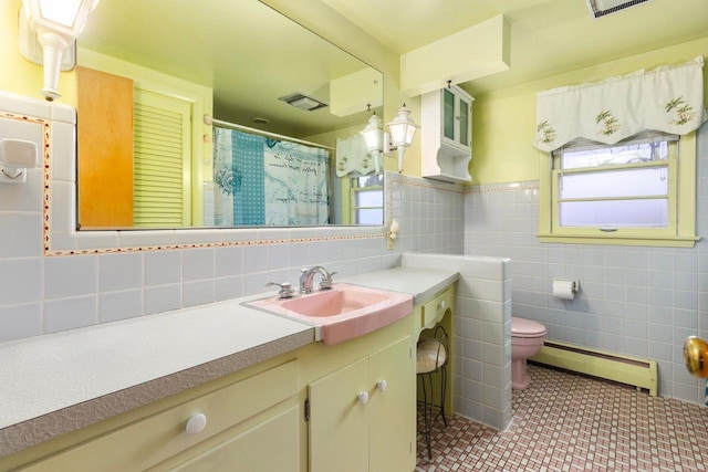 901 E Grant St, Appleton, WI 54911 - full bathroom featuring vanity, toilet, tile walls, a baseboard radiator, and visible vents