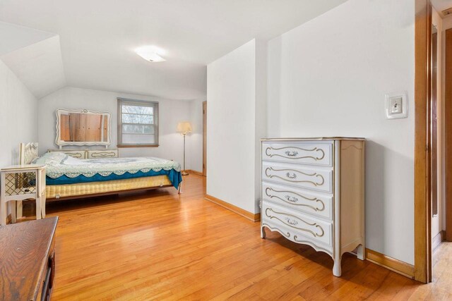 901 E Grant St, Appleton, WI 54911 - bedroom with baseboards, light wood-style flooring, and vaulted ceiling