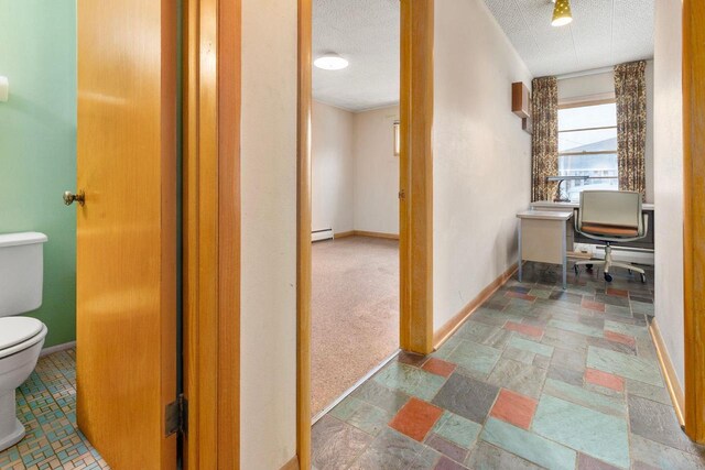 901 E Grant St, Appleton, WI 54911 - hallway featuring baseboards, a baseboard heating unit, stone finish flooring, and a textured ceiling