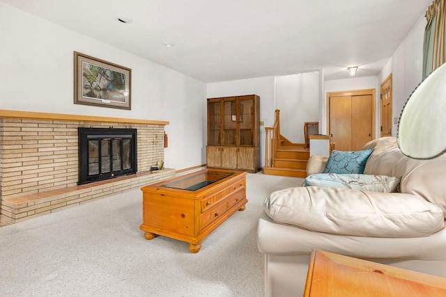 901 E Grant St, Appleton, WI 54911 - living room featuring stairs, a brick fireplace, and light carpet