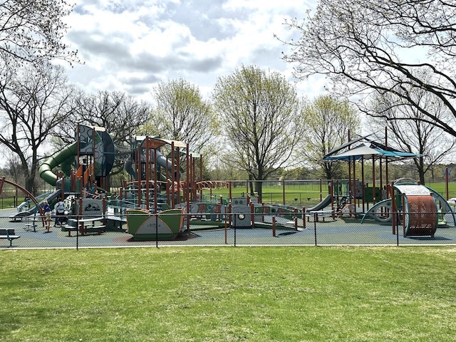 community playground featuring fence and a yard