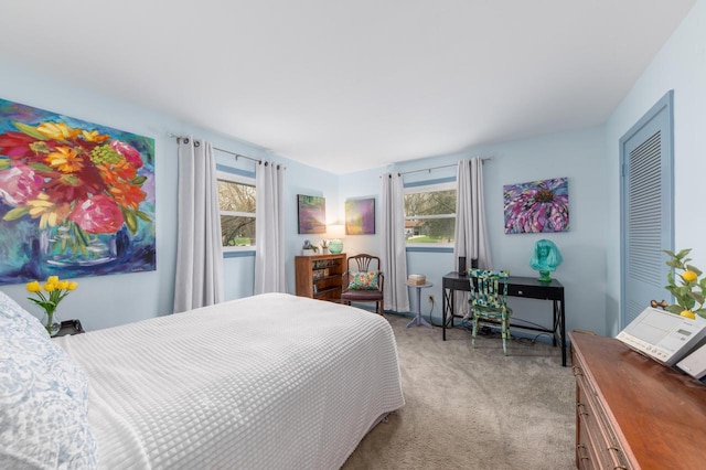 bedroom featuring carpet floors and multiple windows
