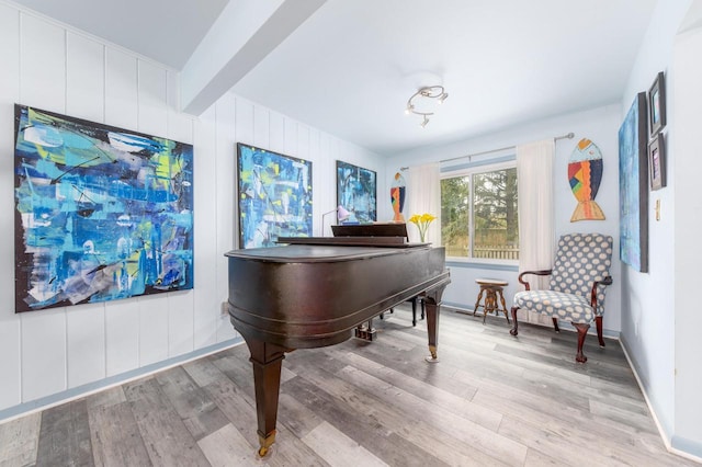 sitting room featuring baseboards and light wood-type flooring