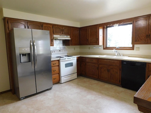 kitchen featuring electric range, black dishwasher, stainless steel fridge, under cabinet range hood, and a sink