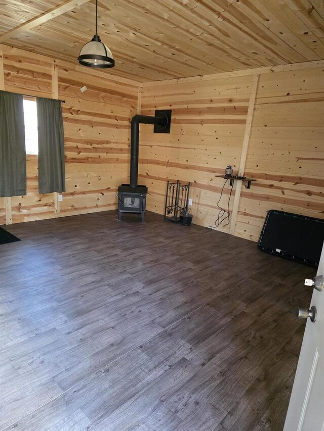 W10686 County Road X, Crivitz, WI 54114 - unfurnished living room featuring wood walls, wooden ceiling, a wood stove, and dark wood-type flooring