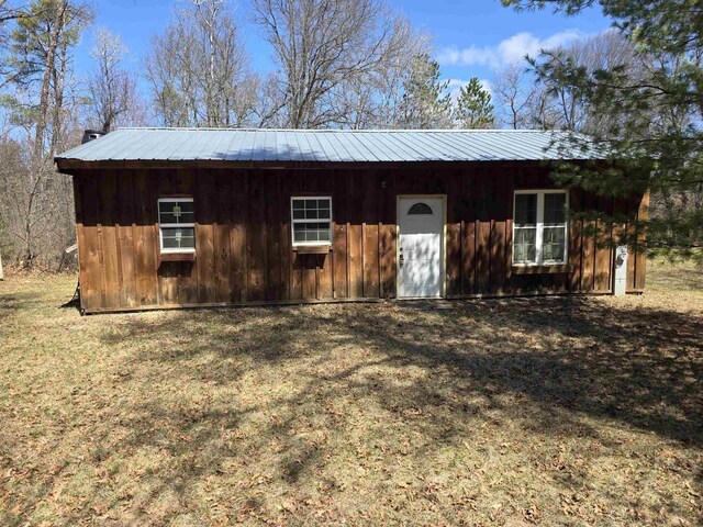 W10686 County Road X, Crivitz, WI 54114 - view of front of home with board and batten siding, metal roof, and a front yard