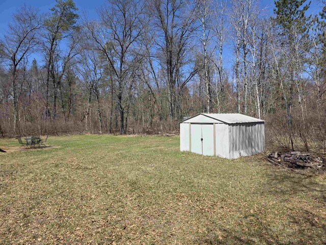 W10686 County Road X, Crivitz, WI 54114 - view of yard with an outdoor structure, a shed, and a forest view