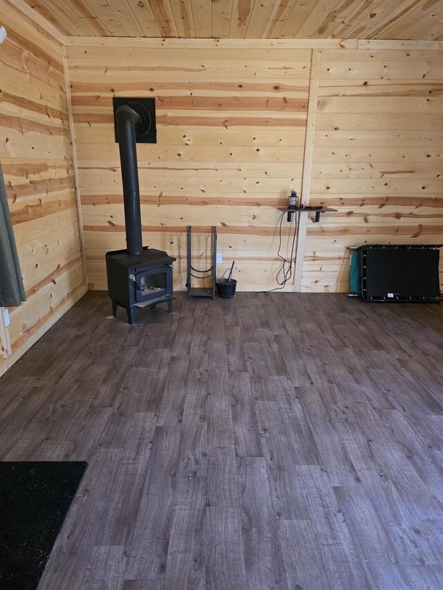 W10686 County Road X, Crivitz, WI 54114 - unfurnished living room with dark wood-type flooring, wood walls, a wood stove, and wooden ceiling