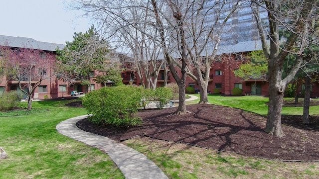 view of property's community with a yard