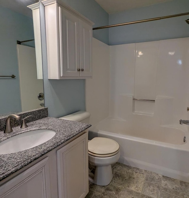 bathroom featuring vanity,  shower combination, and toilet