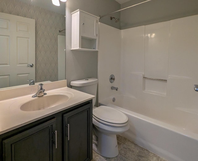 full bathroom with vanity,  shower combination, toilet, and wallpapered walls