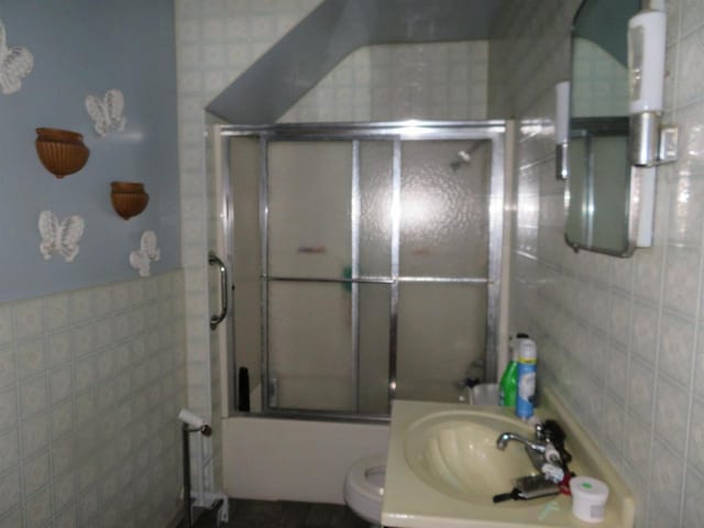 5021 Margaret Dr, Amherst, WI 54406 - bathroom with tile walls, combined bath / shower with glass door, toilet, and vanity