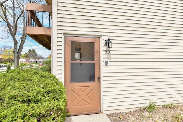 view of exterior entry featuring a balcony