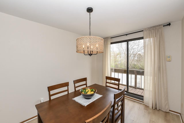 dining room featuring an inviting chandelier and light wood finished floors