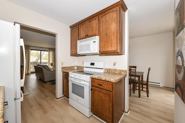kitchen featuring light wood-type flooring, white appliances, and brown cabinetry