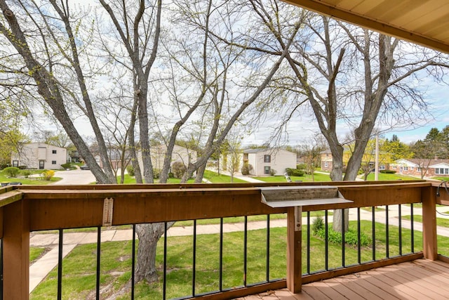 deck featuring a lawn and a residential view