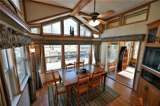 dining area featuring high vaulted ceiling, ceiling fan, beam ceiling, and wood finished floors