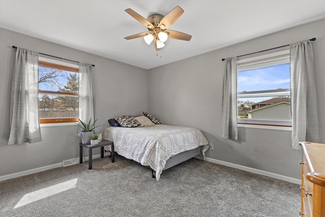 carpeted bedroom featuring visible vents, a ceiling fan, and baseboards